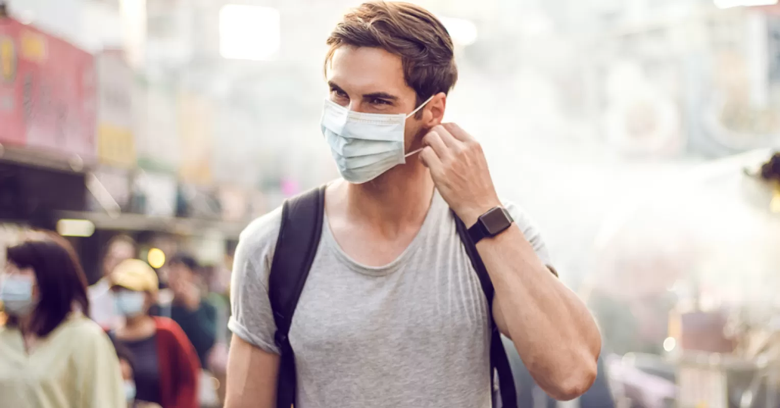 Individual wearing a mask, reflecting social dynamics and hidden emotions in human behavior