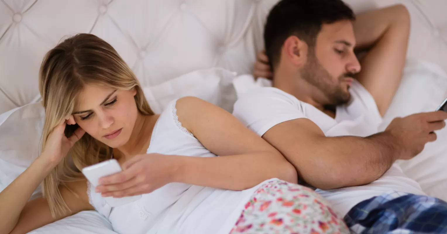 Couple discussing feelings about intimacy and low sex drive in a cozy setting