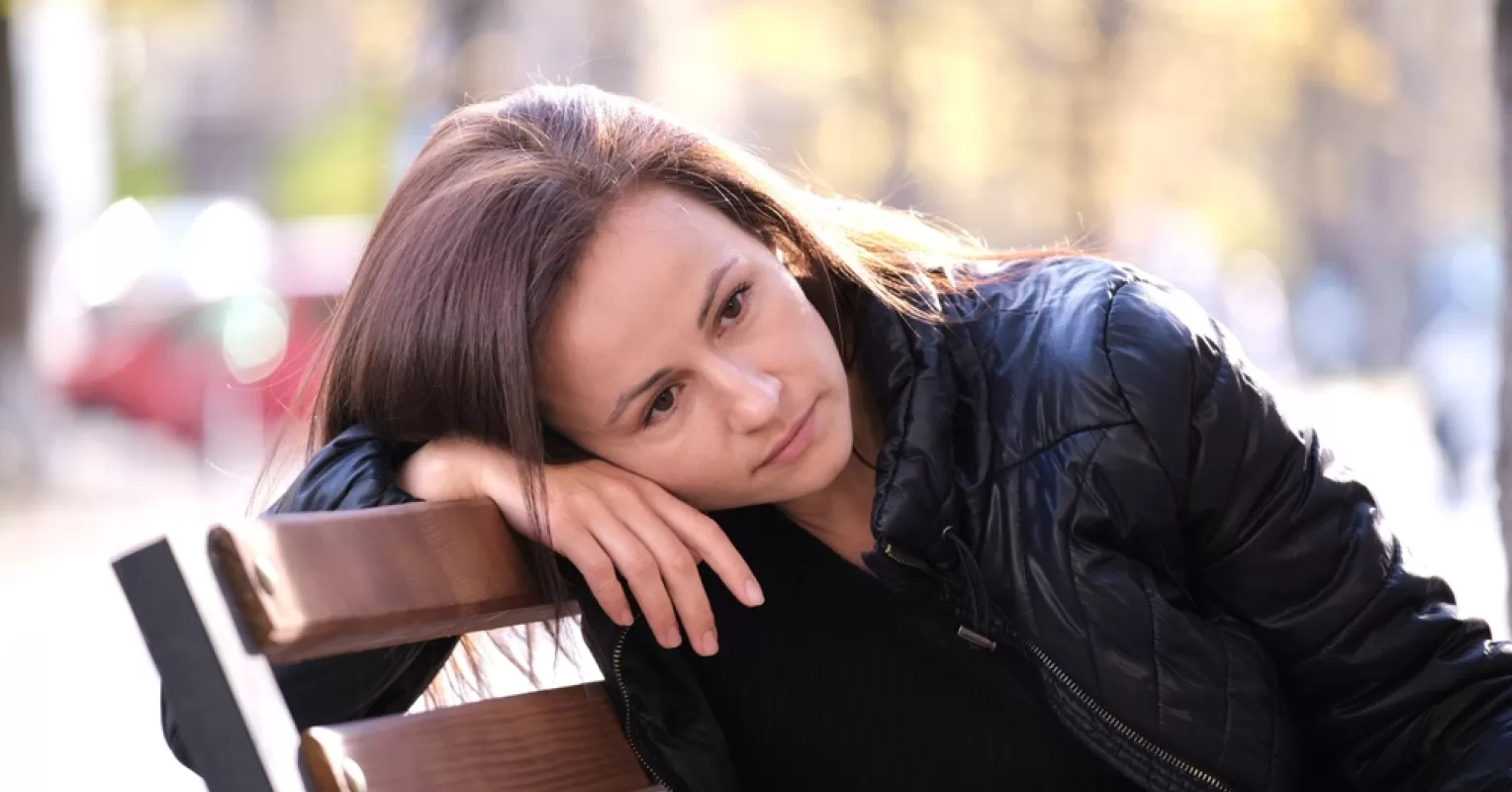 Person contemplating feelings of loss and confusion after a sibling cuts them off