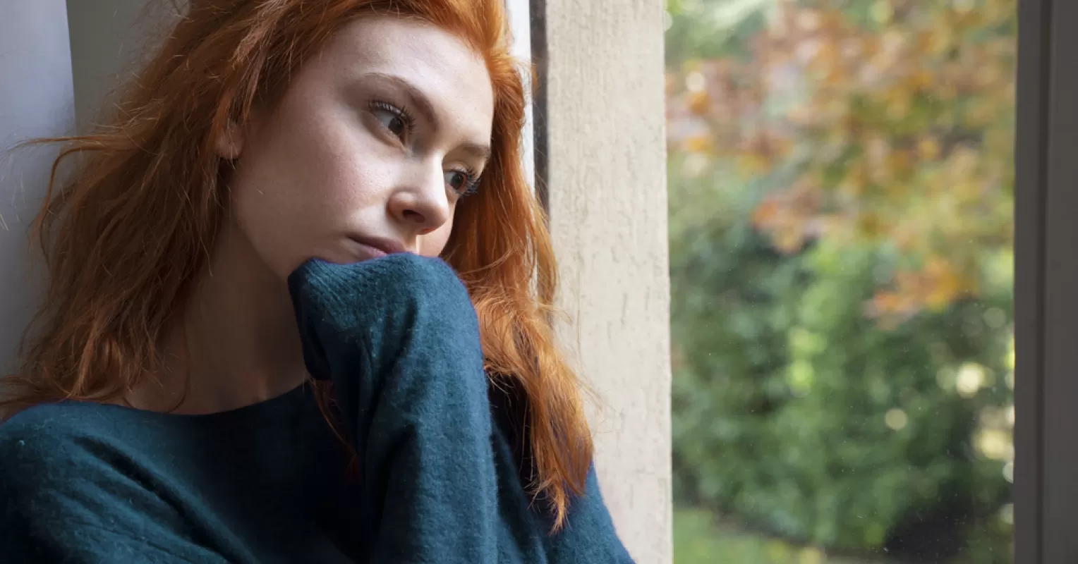 Person pondering emotional signals while dreaming about their ex-partner