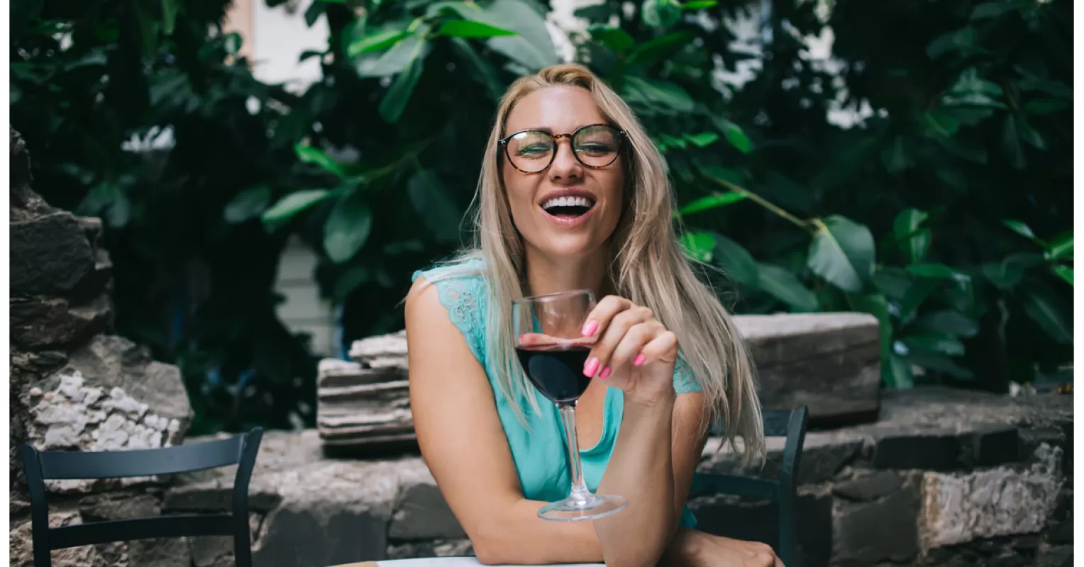 Group of friends laughing and behaving differently at a party after drinking alcohol