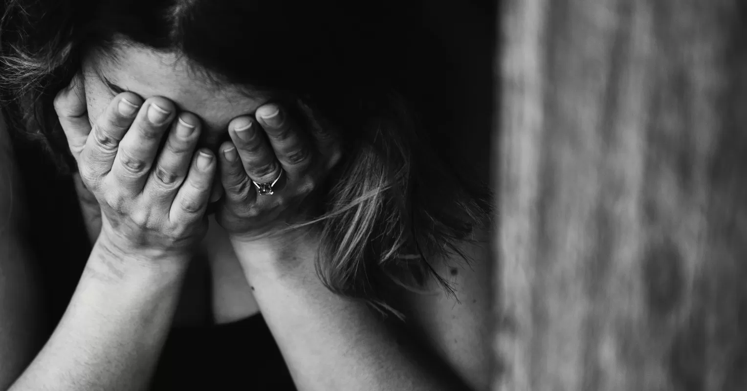 Two siblings sitting apart, reflecting on the emotional signals of estrangement