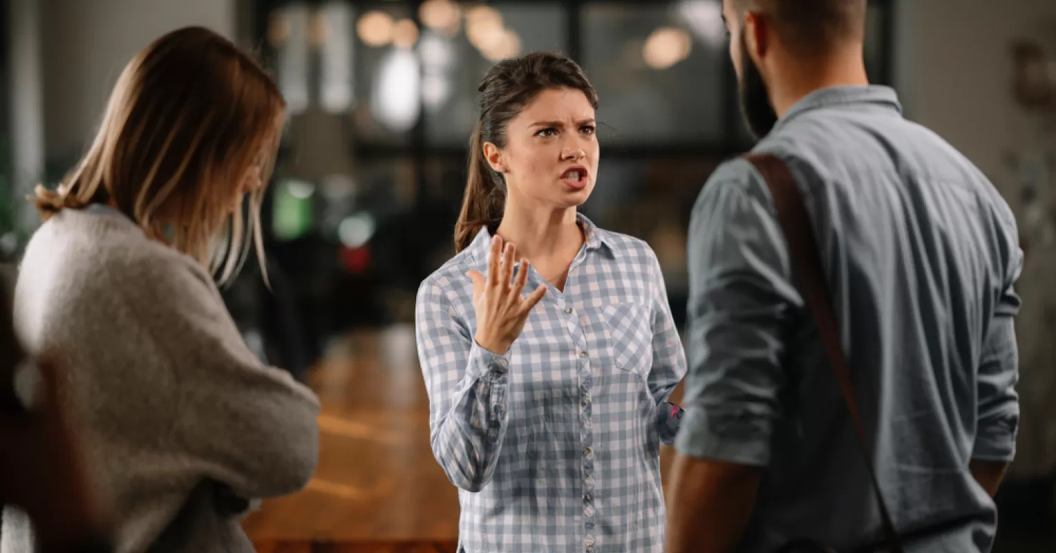 Individual contemplating social dynamics while avoiding confrontation in a tense situation