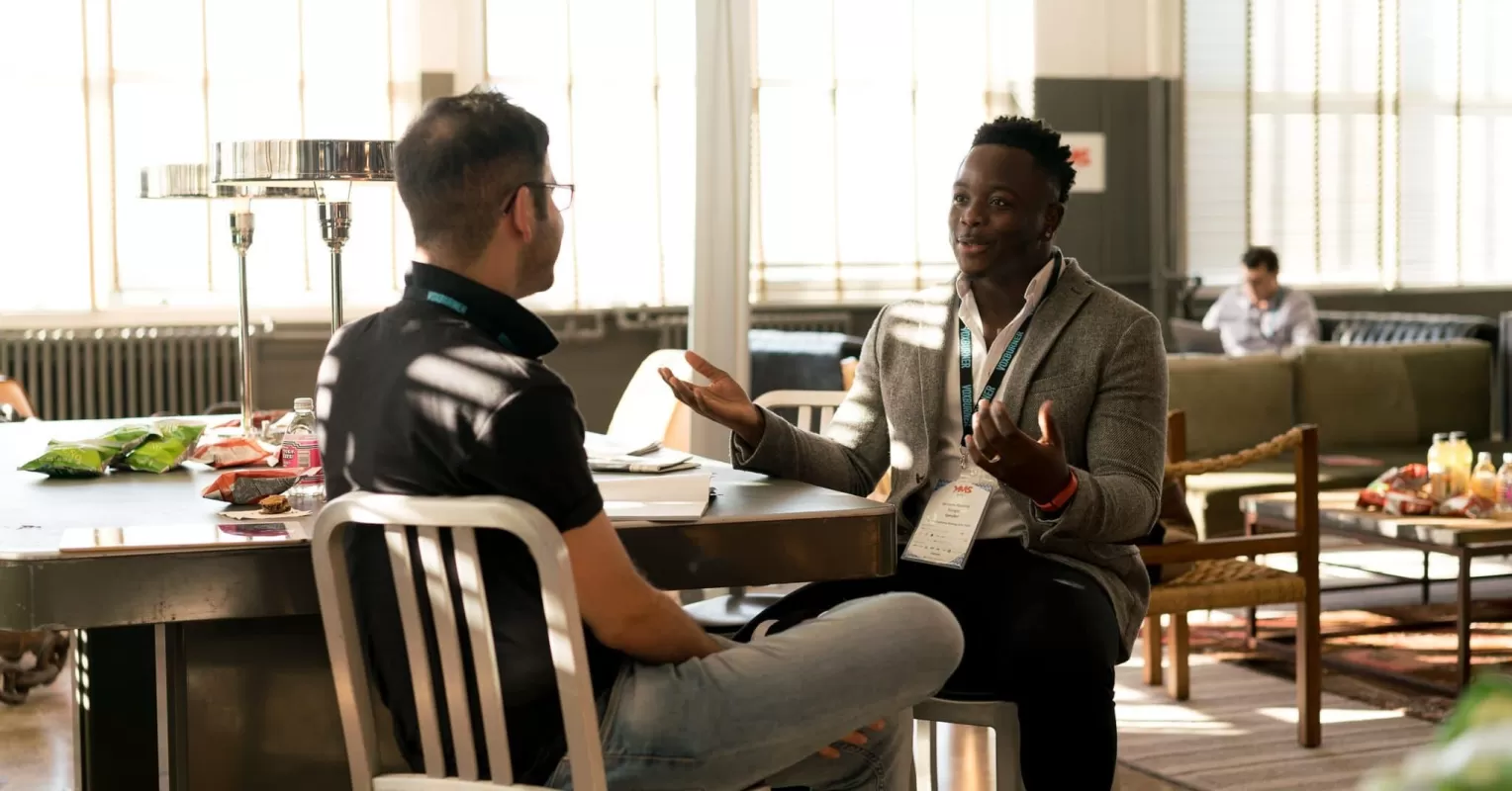 Group of friends engaging in a lively conversation, illustrating how to build connections with others