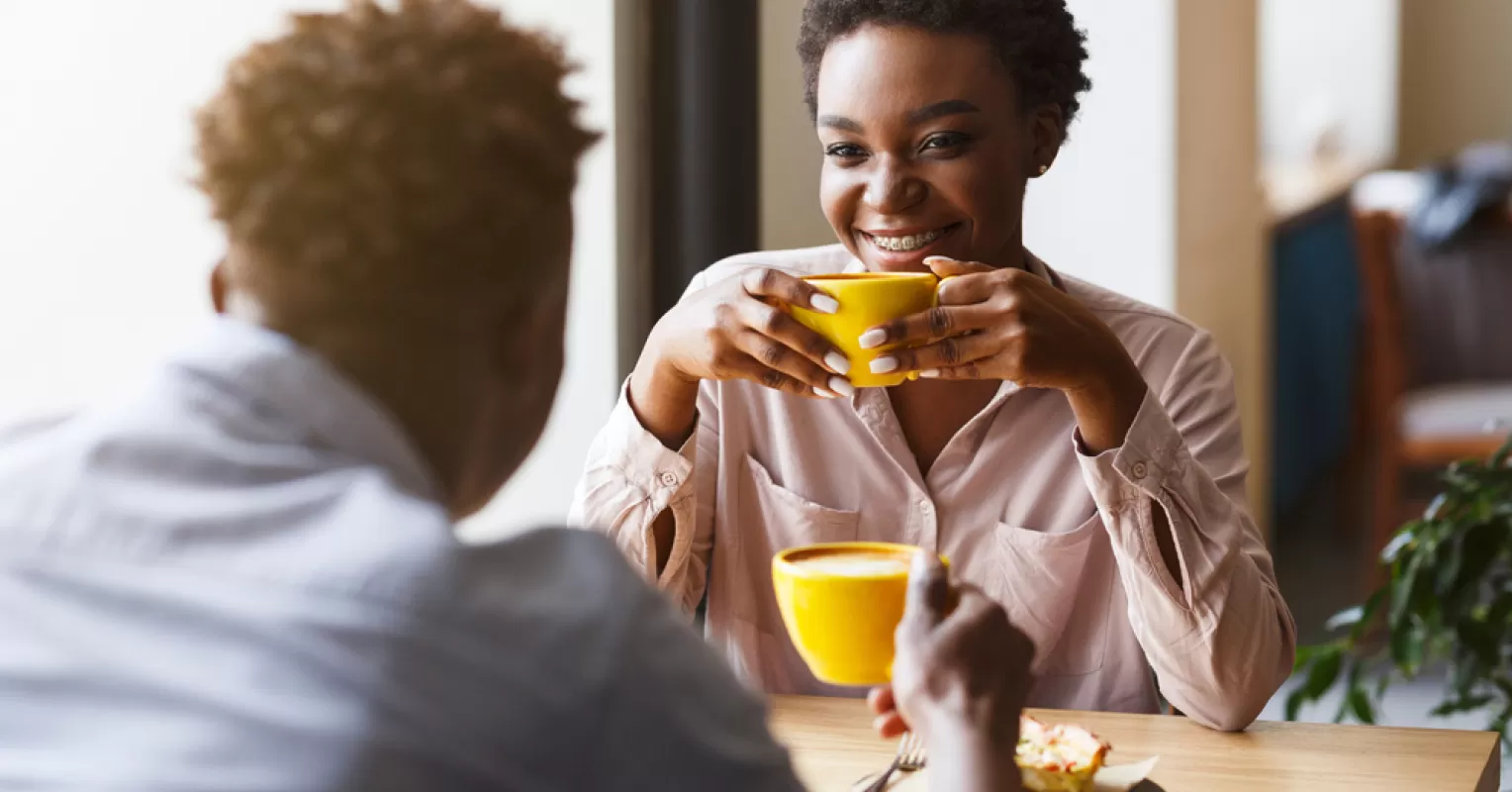 Couple sharing a laugh, showcasing chemistry on a first date through genuine connection
