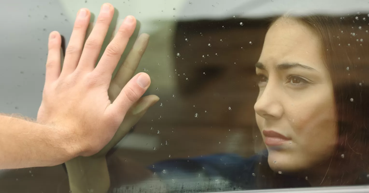 Individual processing emotional pain after a breakup, reflecting on relationship signals.