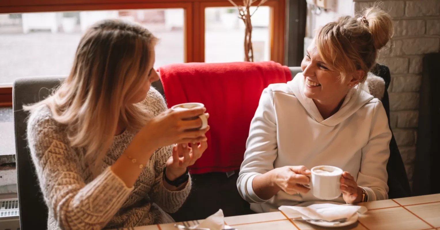 Two people sharing a laugh, demonstrating effective engagement in conversation