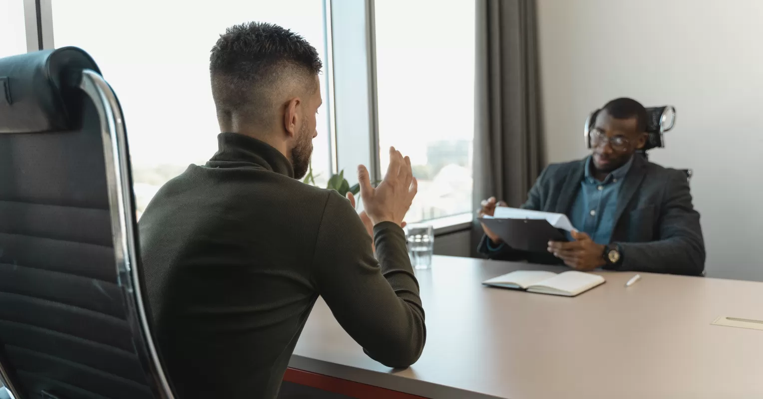 Two friends discussing feedback with open body language and attentive expressions