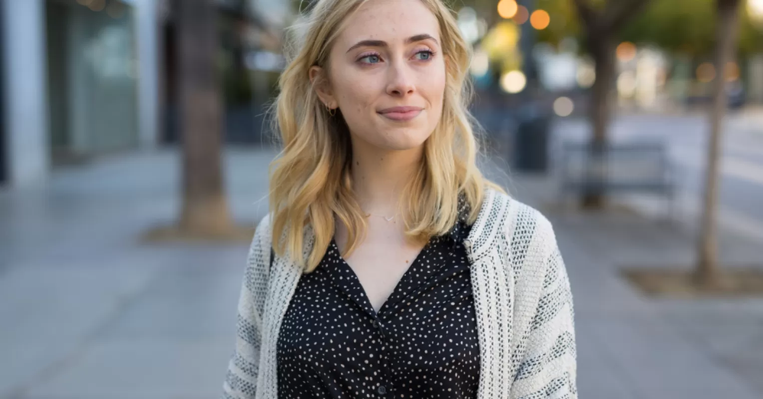 A thoughtful person sitting alone, contemplating how to help introverts open up in conversations