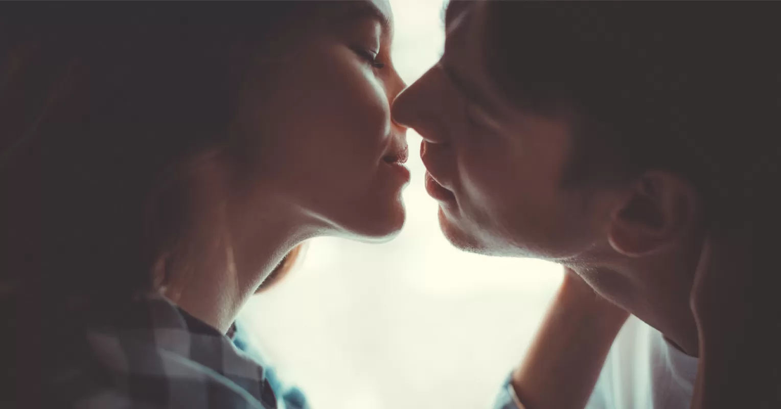 Couple practicing kissing techniques to enhance intimacy and connection in their relationship
