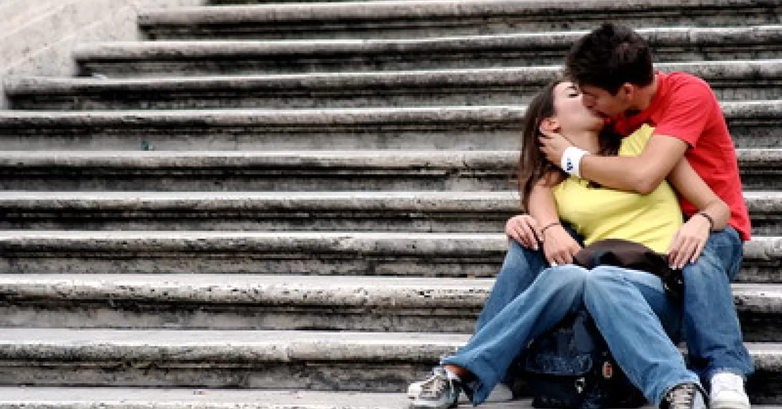 Couple leaning in for their first kiss, sensing relationship signals and emotions