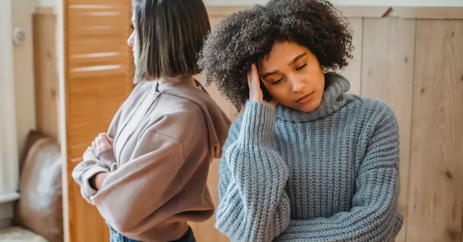 Individual contemplating the emotional burden of holding a grudge in a relationship