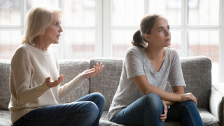 Individual avoiding responsibility while partner seeks accountability in a tense conversation