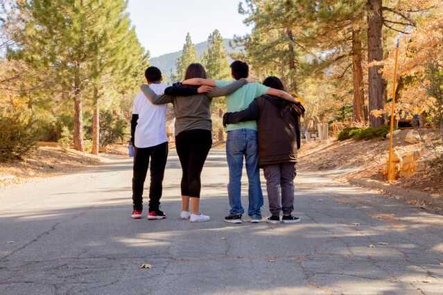 Teenagers engaging in a group activity that fosters empathy and social dynamics
