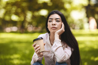 Individual contemplating feelings of guilt versus shame in a serene environment