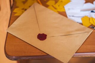 Person writing a heartfelt note to express gratitude for life-changing support
