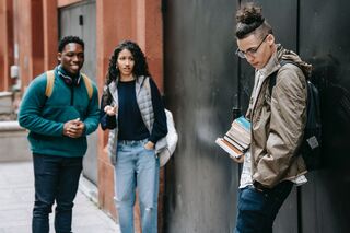 Group of friends engaged in conversation, revealing the dynamics of why people gossip about others