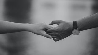 Person reflecting on uncertainty in a relationship connected to do opposites attract in relationships