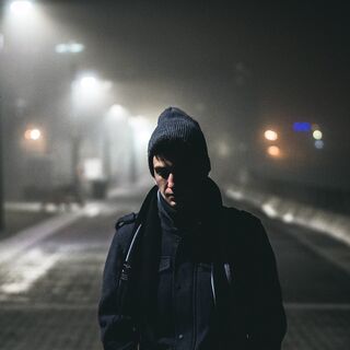 Individual feeling isolated in a social setting, reflecting on why some people struggle to make friends