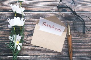 Team members sharing a moment of appreciation during a workplace meeting