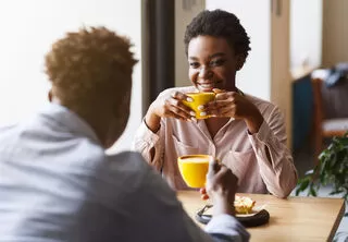Couple sharing a laugh, showcasing relationship signals of chemistry on a first date