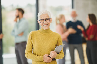 Employee showing signs of disengagement during a team meeting, reflecting relationship signals in the workplace
