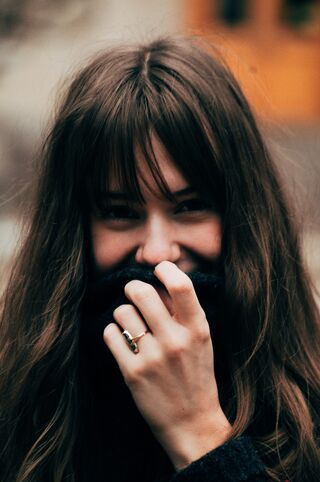 A person blushing while making eye contact with someone they admire, showcasing human behavior.