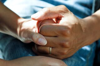 A supportive friend comforting someone experiencing grief, highlighting social dynamics in emotional support