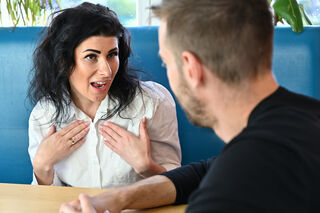 A person looking puzzled while interacting with a passive-aggressive friend, reflecting on relationship signals.
