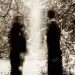 Two siblings sitting apart, reflecting on their estrangement and emotional distance.