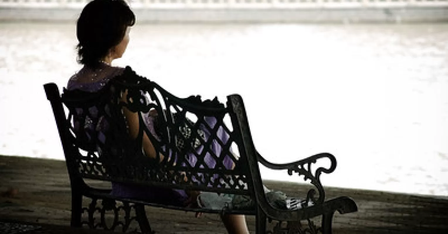 Elderly person sitting alone, reflecting on signs of loneliness in elderly life
