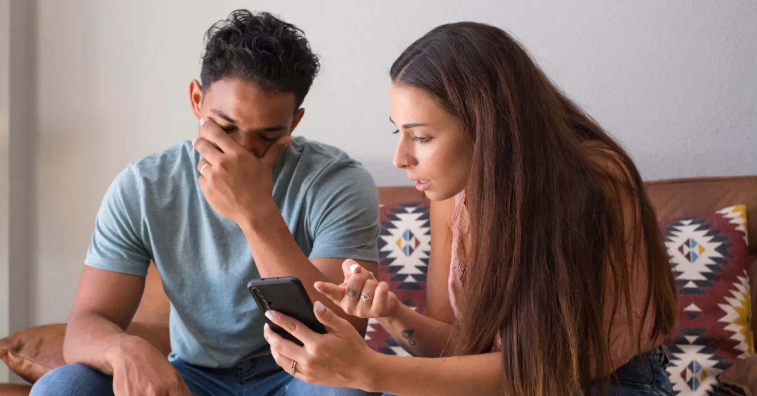 Couple discussing trust issues while examining signs of potential infidelity