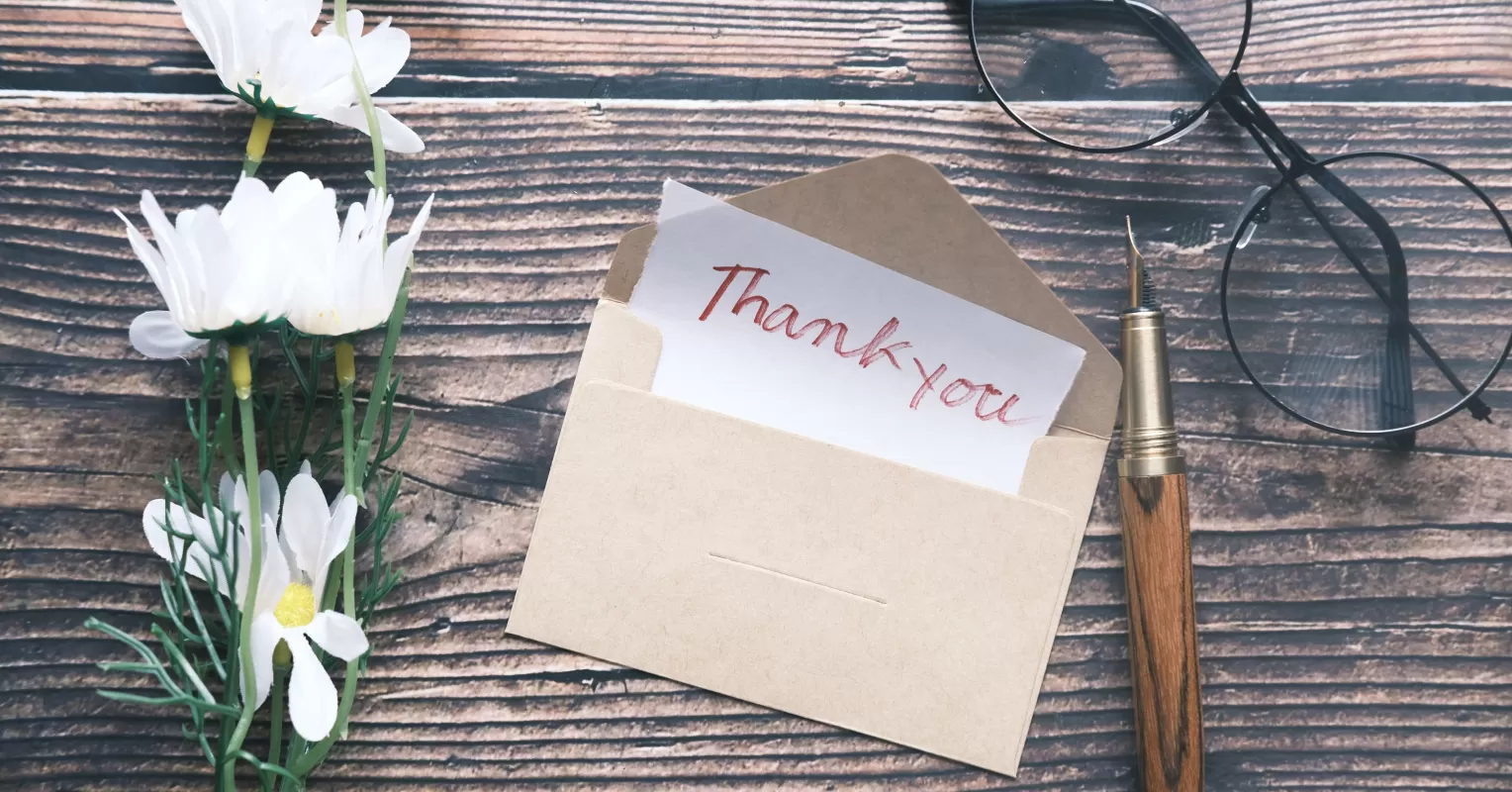 Team members sharing a moment of appreciation during a workplace meeting