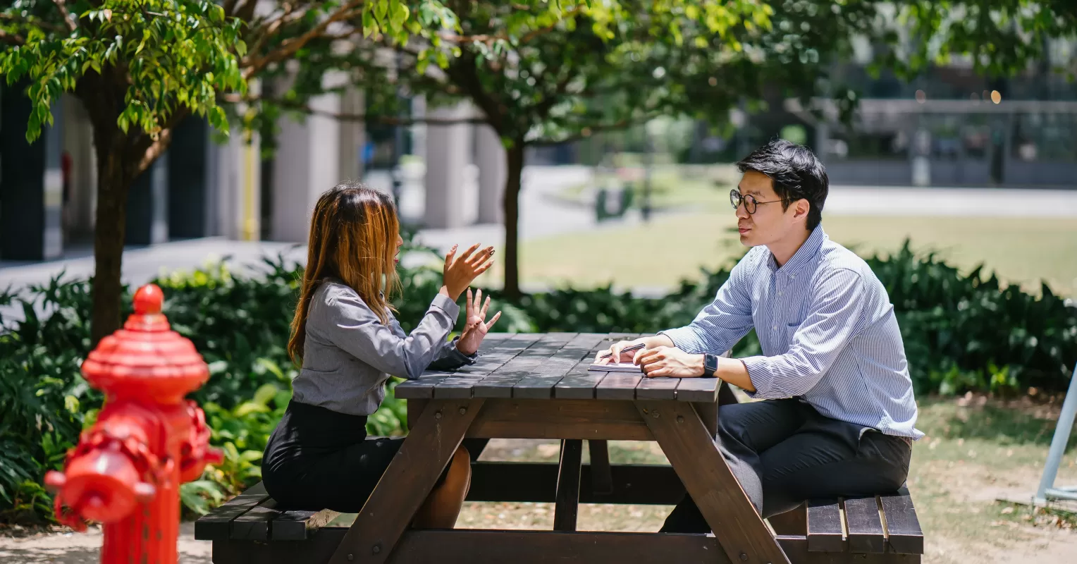 Individual experiencing discomfort in a social gathering, reflecting on why they feel awkward in social situations