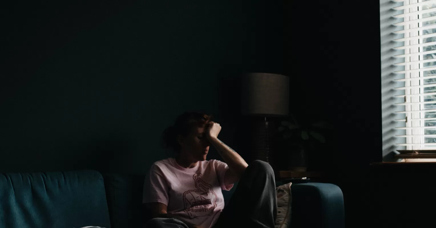 Individual contemplating the fear of intimacy while pushing loved ones away